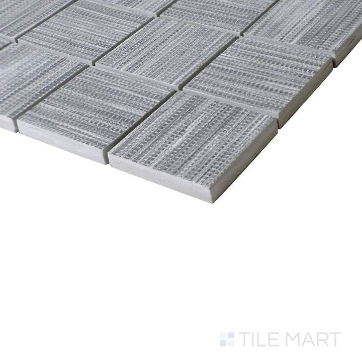 Diagonal view of Wooow Linen Silver 2" square matte porcelain mosaic, showcasing a cool silver tone, a subtle fabric-like texture, and a classic square layout.  