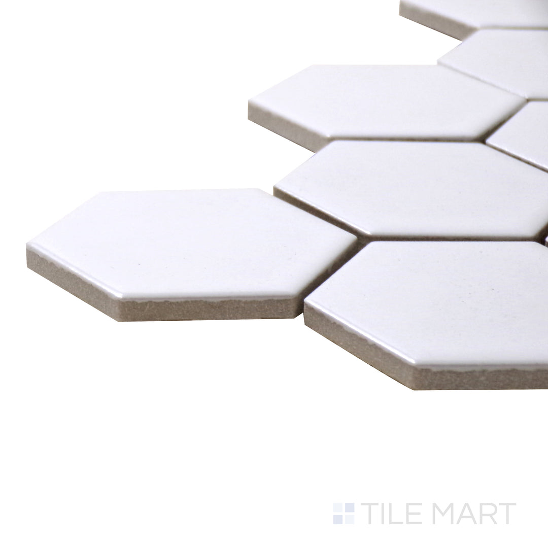 Corner-focused shot of Retro White 2" Hexagon Glossy Porcelain Mosaic, highlighting its bright white hexagonal design with a sleek glossy surface.