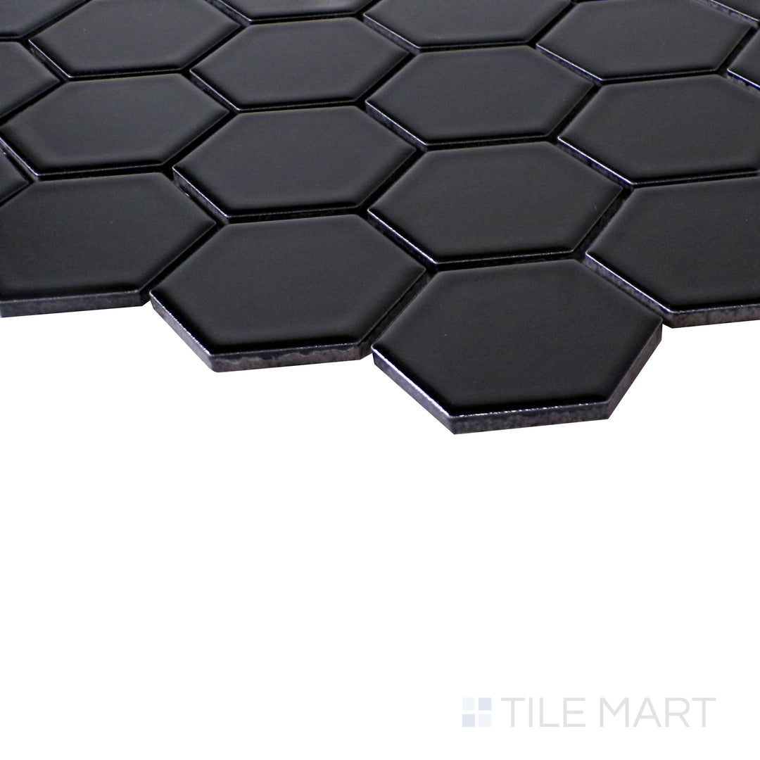 Slanted perspective of Retro Black 2" hexagon matte porcelain mosaic, emphasizing its bold black color, smooth matte texture, and geometric hexagon design.  