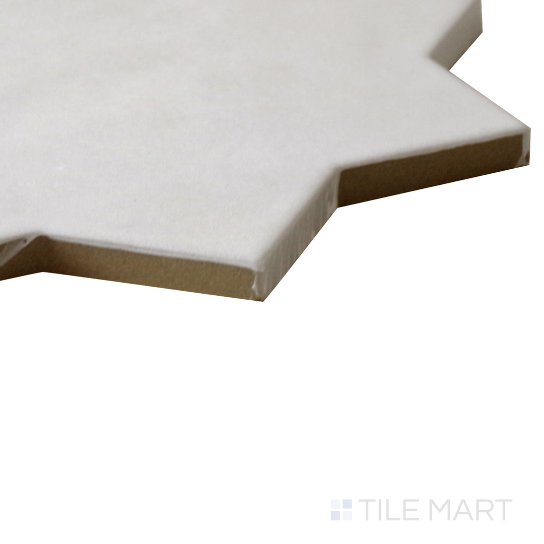 Angled shot of Kasbah Star Bone 6.5x6.5 matte porcelain tile, featuring soft bone tones, star-shaped detailing, and a smooth matte surface.  