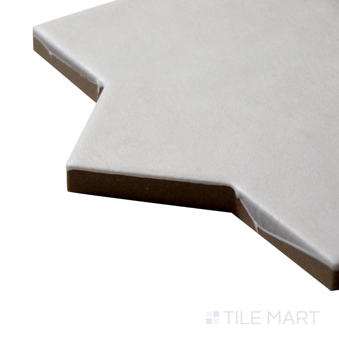Corner angle of Kasbah Star Bone 6.5X6.5 Matte Porcelain Tile, emphasizing its neutral bone shade with a detailed star motif and a smooth matte surface.