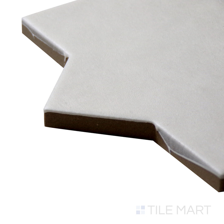 Corner angle of Kasbah Star Bone 6.5X6.5 Matte Porcelain Tile, emphasizing its neutral bone shade with a detailed star motif and a smooth matte surface.