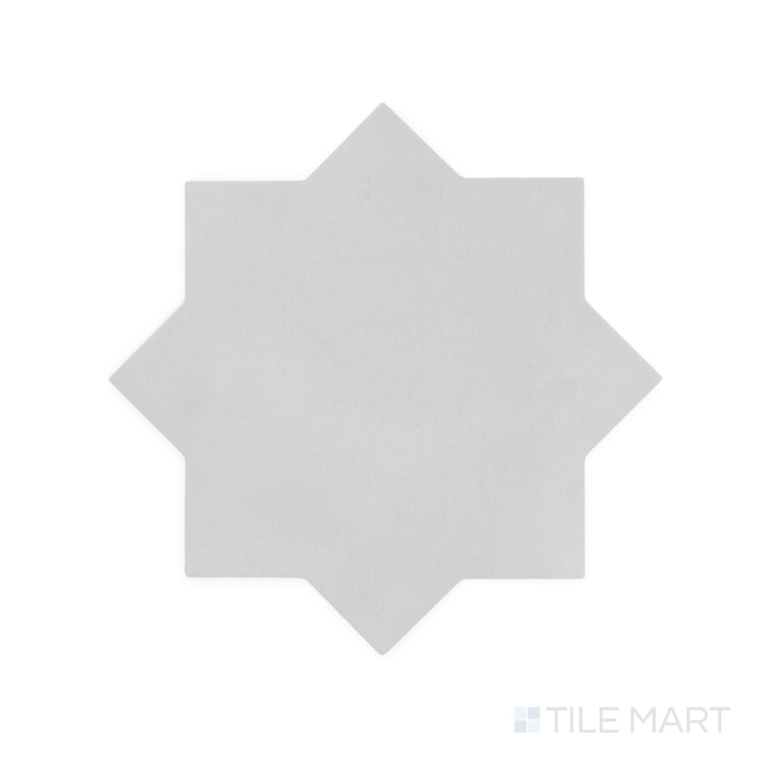 Diagonal view of Kasbah Star Smoke 6.5x6.5 matte porcelain tile, showcasing its cool gray shade, intricate star pattern, and refined matte finish.  
