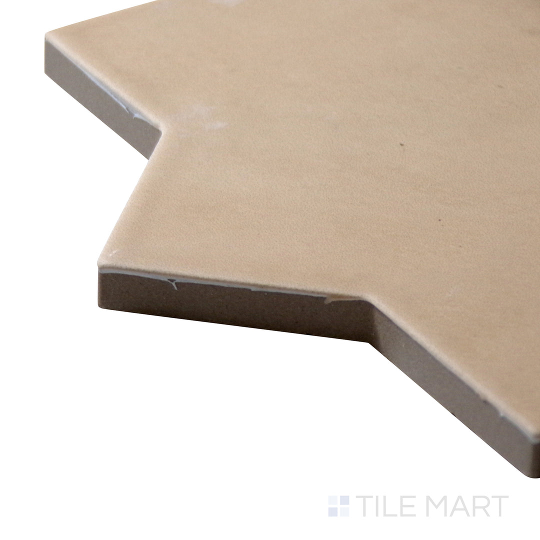 Angled close-up of Kasbah Star Fawn 6.5X6.5 Matte Porcelain Tile, showcasing its warm beige color with a decorative star pattern for a timeless appeal.