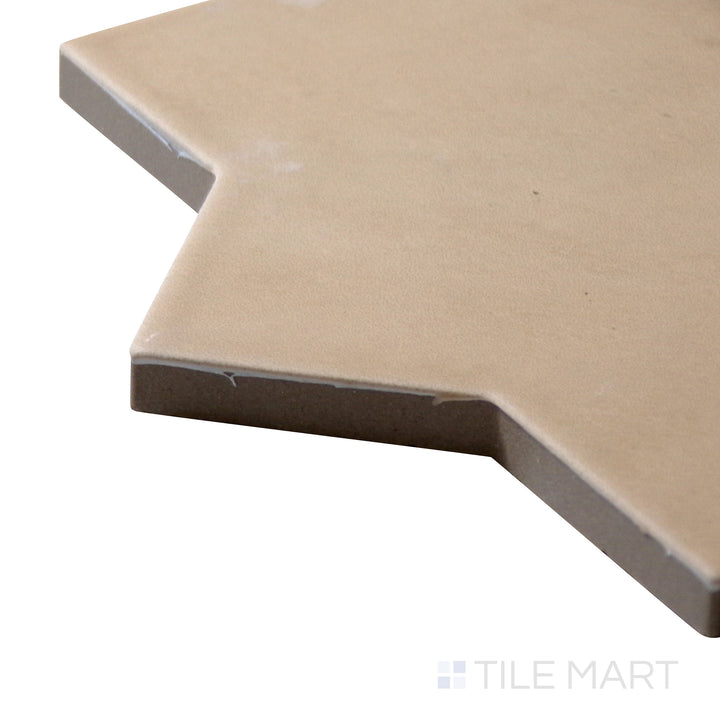 Angled close-up of Kasbah Star Fawn 6.5X6.5 Matte Porcelain Tile, showcasing its warm beige color with a decorative star pattern for a timeless appeal.