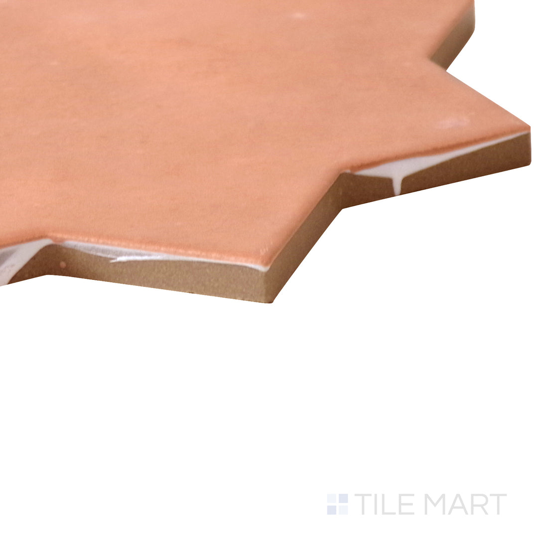 Angled shot of Kasbah Star Terracotta 6.5x6.5 matte porcelain tile, featuring a rich terracotta color, geometric star pattern, and a smooth matte surface.  