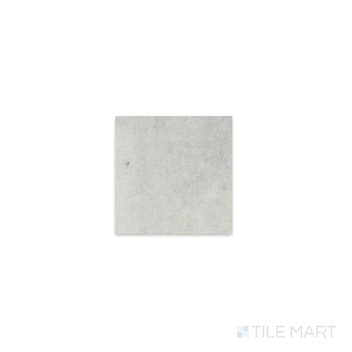 Diagonal view of Kasbah Taco Amber Grey 1x1 matte porcelain tile, showcasing its neutral amber-gray tone, sleek matte texture, and small square format.  
