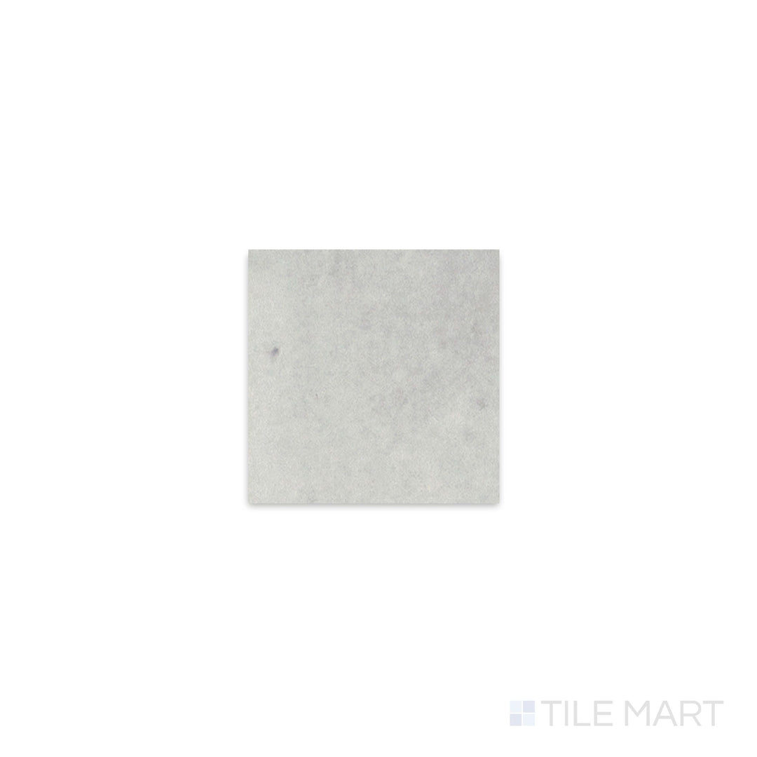 Diagonal view of Kasbah Taco Amber Grey 1x1 matte porcelain tile, showcasing its neutral amber-gray tone, sleek matte texture, and small square format.  
