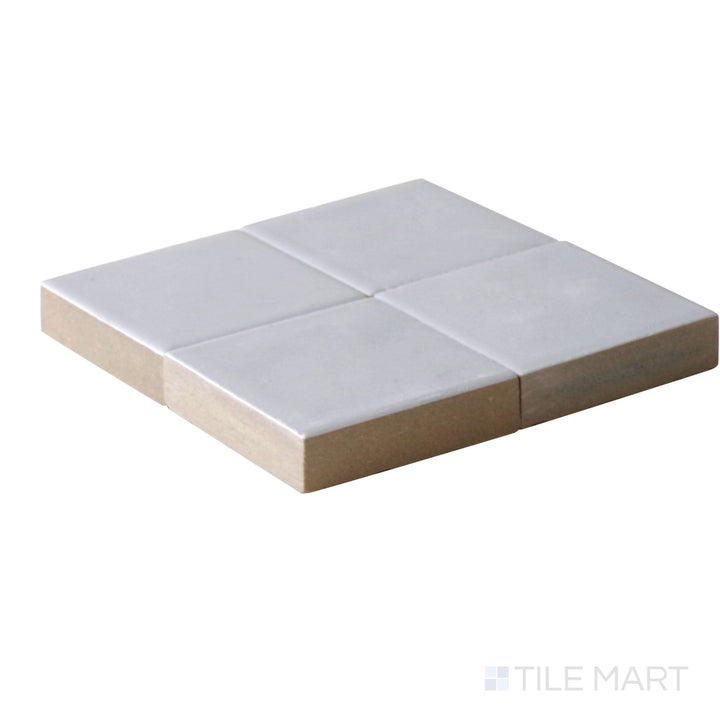 Close-up corner shot of Kasbah Taco Amber Grey 1X1 Matte Porcelain Tile, featuring its soft amber-gray shade with a refined, matte texture.
