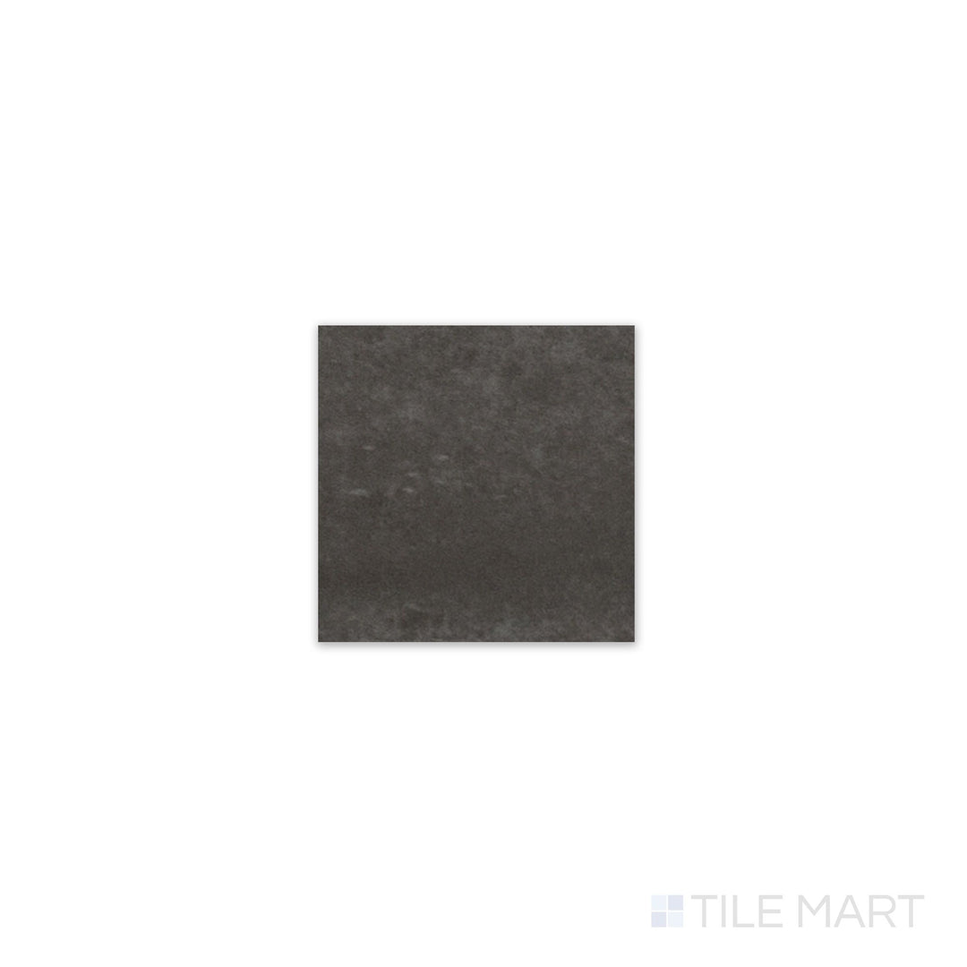 Slanted perspective of Kasbah Taco Black Hat 1x1 matte porcelain tile, emphasizing its deep black hue, smooth matte surface, and precise square design.  
