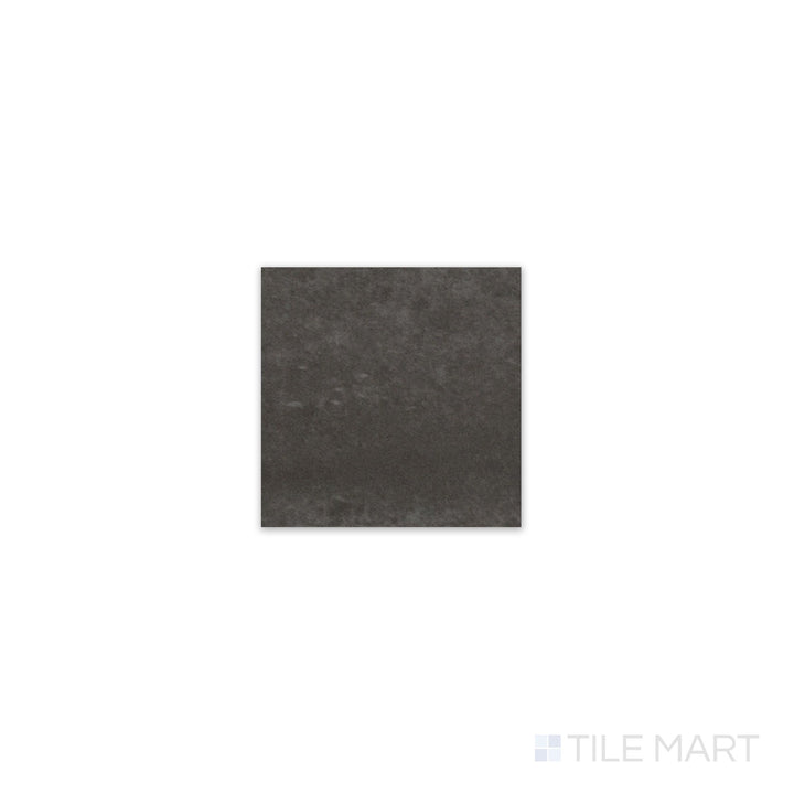 Slanted perspective of Kasbah Taco Black Hat 1x1 matte porcelain tile, emphasizing its deep black hue, smooth matte surface, and precise square design.  
