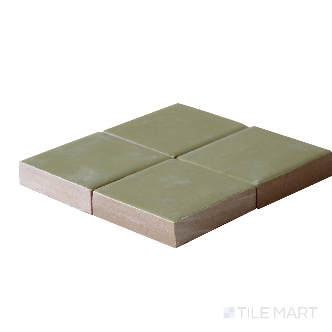 Angled close-up of Kasbah Taco Verde 1X1 Matte Porcelain Tile, showcasing its fresh green tones with a smooth, matte finish.
