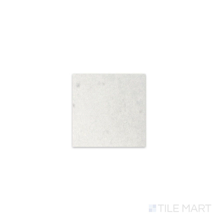 Slanted perspective of Kasbah Taco White 1x1 matte porcelain tile, emphasizing its crisp white color, soft matte finish, and geometric square pattern.  
