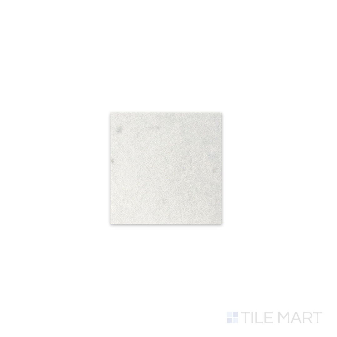 Slanted perspective of Kasbah Taco White 1x1 matte porcelain tile, emphasizing its crisp white color, soft matte finish, and geometric square pattern.  
