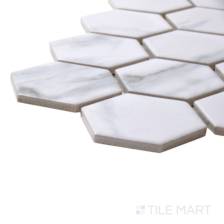 Angled view of Porcelain Glazed Mosaics Carrara White 2" Square Matte Tile, highlighting its refined white marble design with a non-reflective surface in a structured square format.