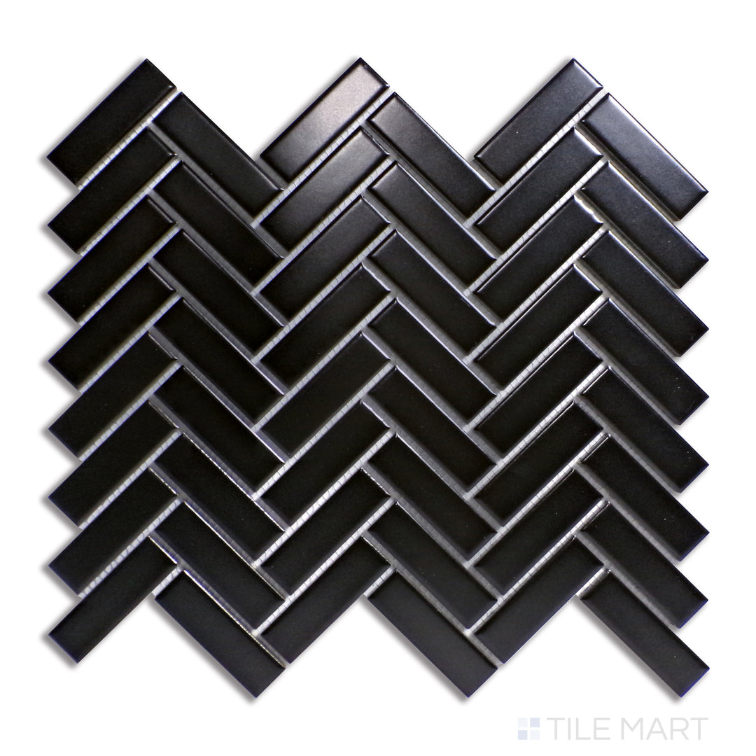 Flat-lay of Porcelain Glazed Mosaics Black Herringbone Matte, a bold mosaic tile with a deep black hue arranged in an eye-catching herringbone pattern.