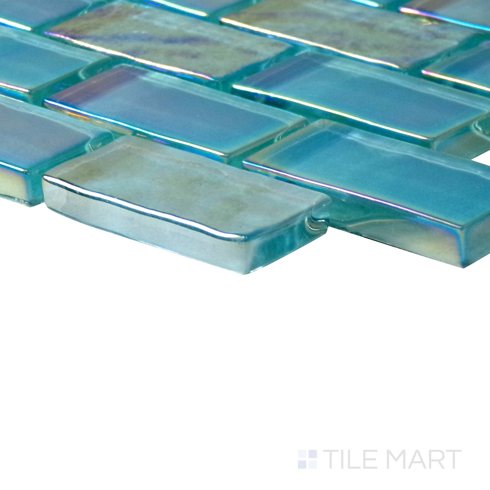 Diagonal view of Vidrofina Aguamarina brick glossy glass mosaic, showcasing its bold aquamarine tones, glossy reflective finish, and contemporary brick layout.  