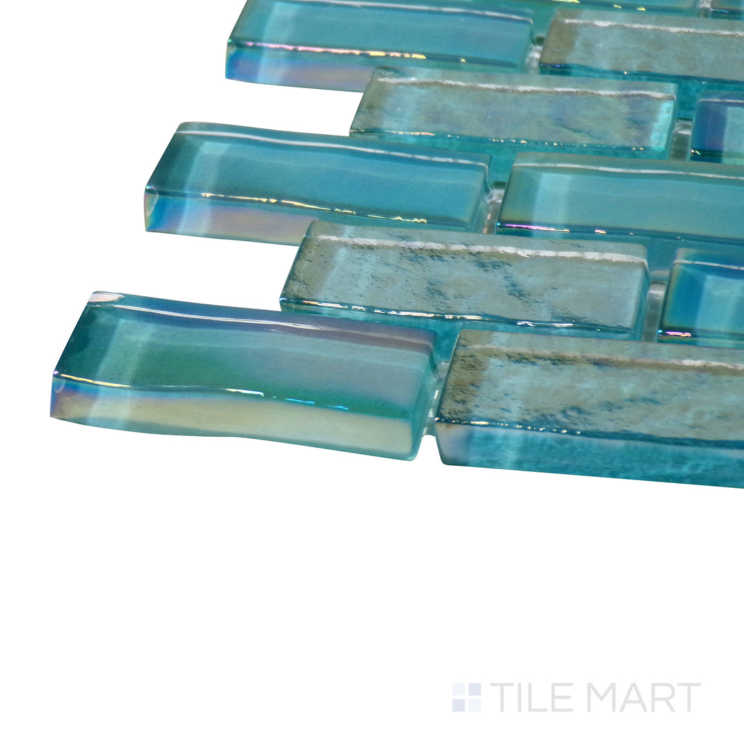 Angled close-up of Vidrofina Aguamarina Brick Glossy Glass Mosaic, showcasing its bright aqua-green tones with a sleek brick-style glass layout.