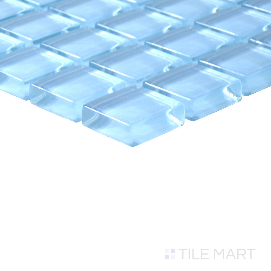 Angled shot of Vidrofina Clarity Blue 1" square glossy glass mosaic, featuring a cool blue shade, a sleek polished finish, and a structured square pattern.  
