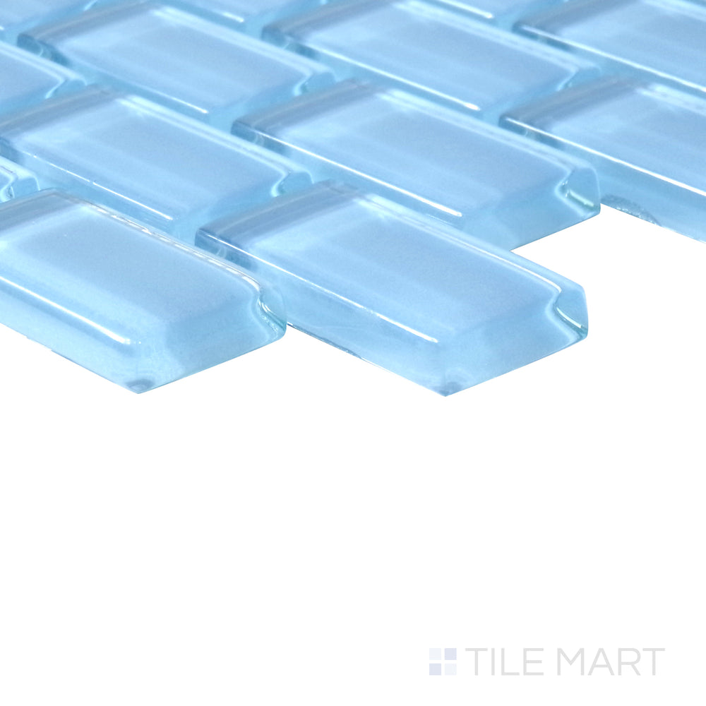 Angled shot of Vidrofina Clarity Blue brick glossy glass mosaic, featuring a vibrant blue hue, sleek glossy finish, and structured brick layout.  