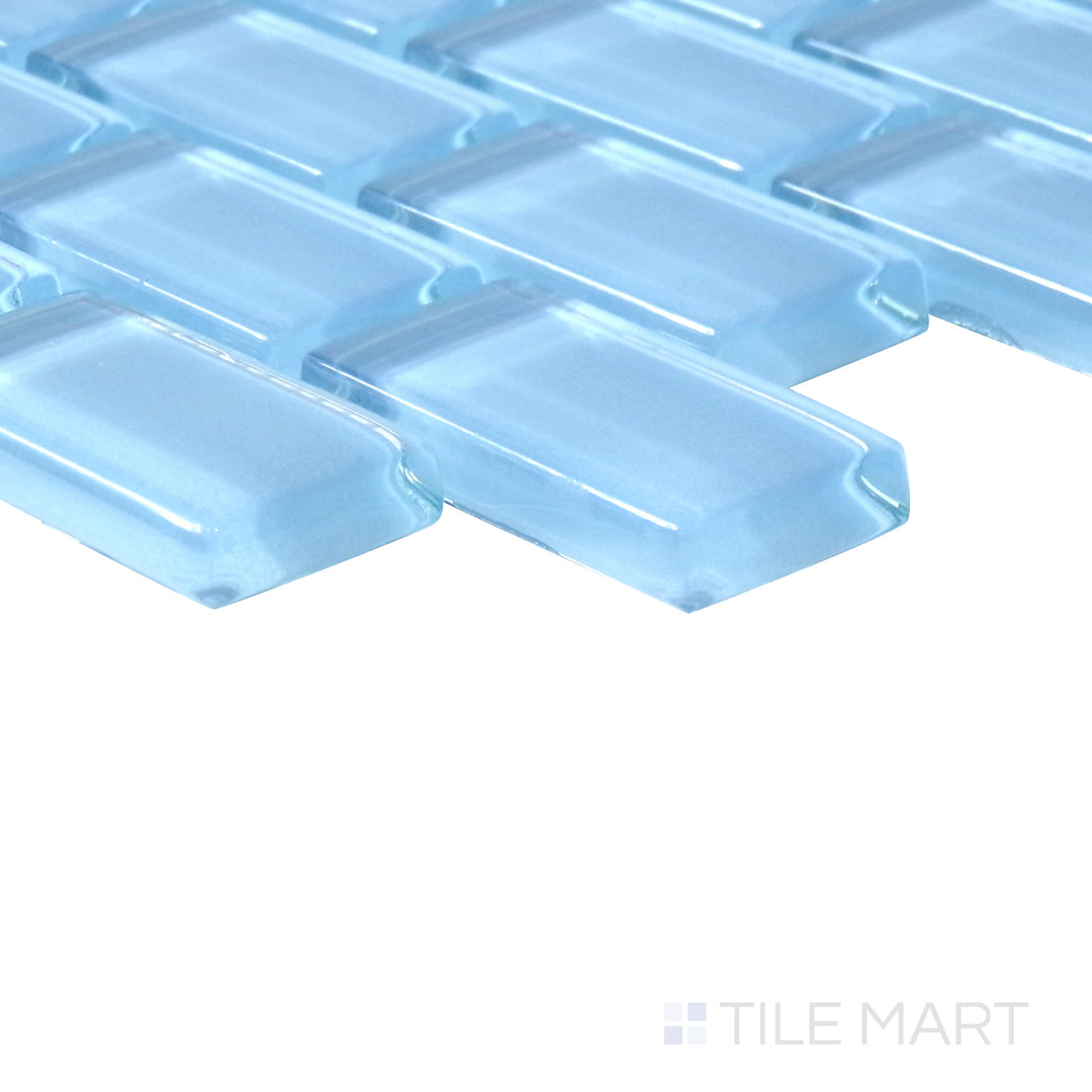 Angled shot of Vidrofina Clarity Blue brick glossy glass mosaic, featuring a vibrant blue hue, sleek glossy finish, and structured brick layout.  
