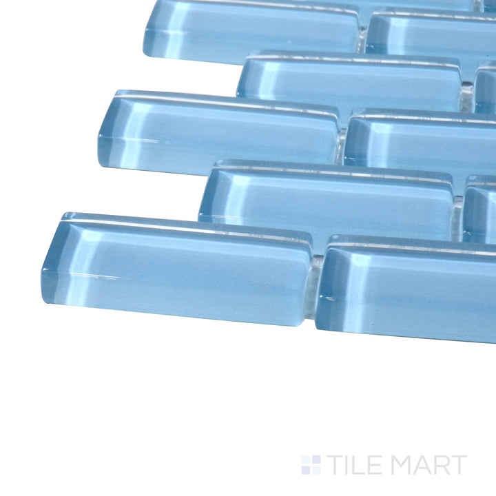 Close-up corner shot of Vidrofina Clarity Blue Brick Glossy Glass Mosaic, featuring its cool blue shade in a structured brick-style glass layout with a sleek polished finish.