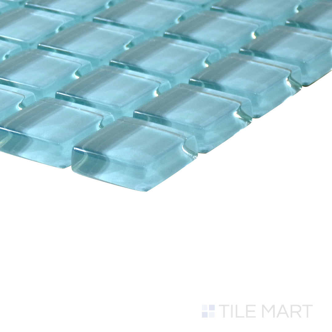 Diagonal view of Vidrofina Larimar Green 1" square glossy glass mosaic, showcasing its refreshing green hues, a high-gloss surface, and uniform square layout.  