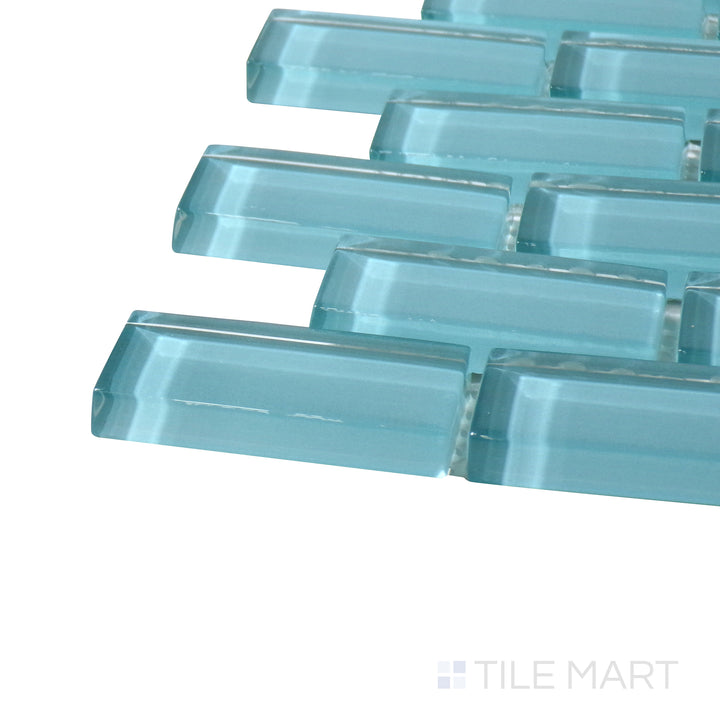 Side perspective of Vidrofina Larimar Green Brick Glossy Glass Mosaic, capturing its striking greenish-blue hues with a contemporary brick-style arrangement and glossy texture.