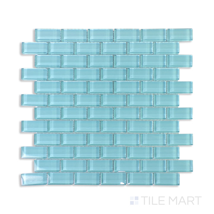 Flat-lay of Vidrofina Larimar Green Brick Glossy Glass Mosaic, a lush green glass mosaic in a brick pattern, adding depth and shine to any design.