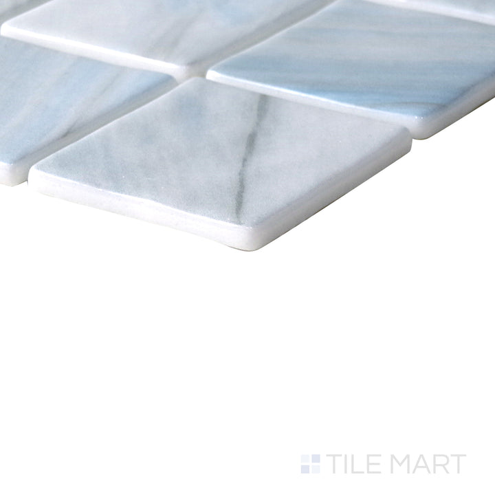 Diagonal view of Onix Glass Zhoe 2" square glossy mosaic, showcasing its vibrant color, smooth polished surface, and contemporary square format.  