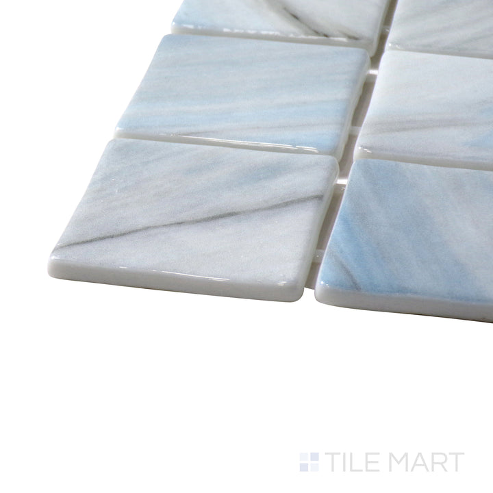 Angled view of Onix Glass Zhoe 2" Square Glossy Mosaic, highlighting its reflective surface and contemporary square design.