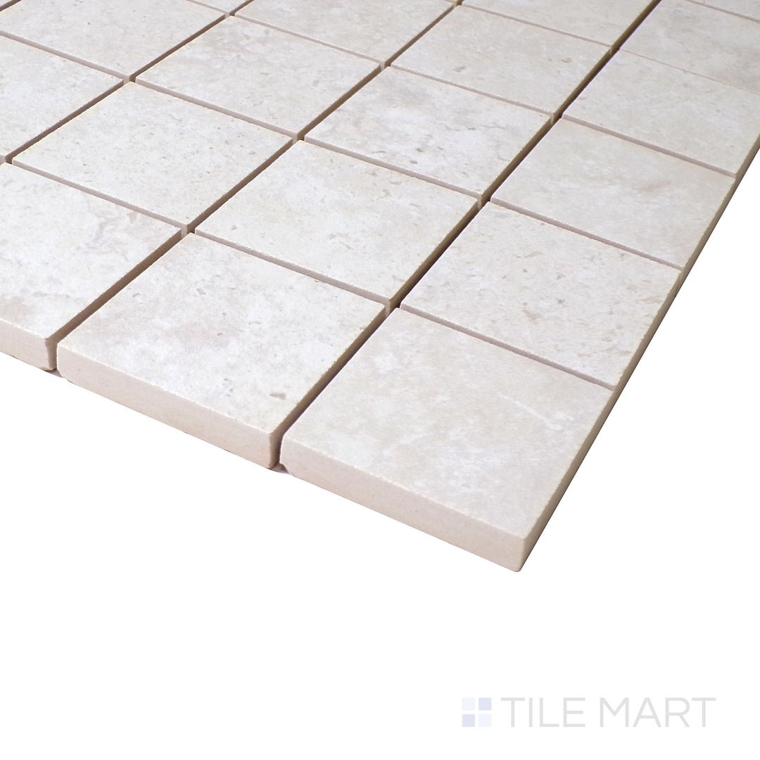 Slanted perspective of Astrum White 2" square matte porcelain mosaic, emphasizing its bright white shade, structured square pattern, and soft matte finish.  