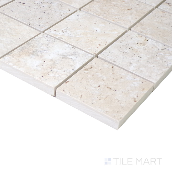 Angled shot of Astrum Ivory 2" square matte porcelain mosaic, featuring warm ivory hues, a smooth matte texture, and a geometric square arrangement.  