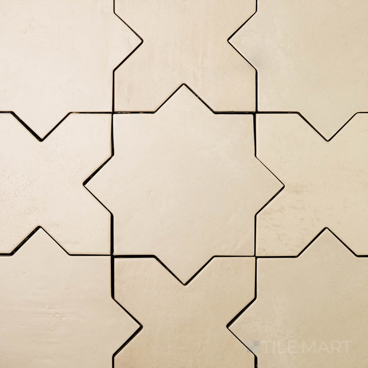 Overhead shot of Amalfi Star Bone 7X7 Matte Porcelain, a soft beige tile with a sophisticated star design and a modern matte surface.