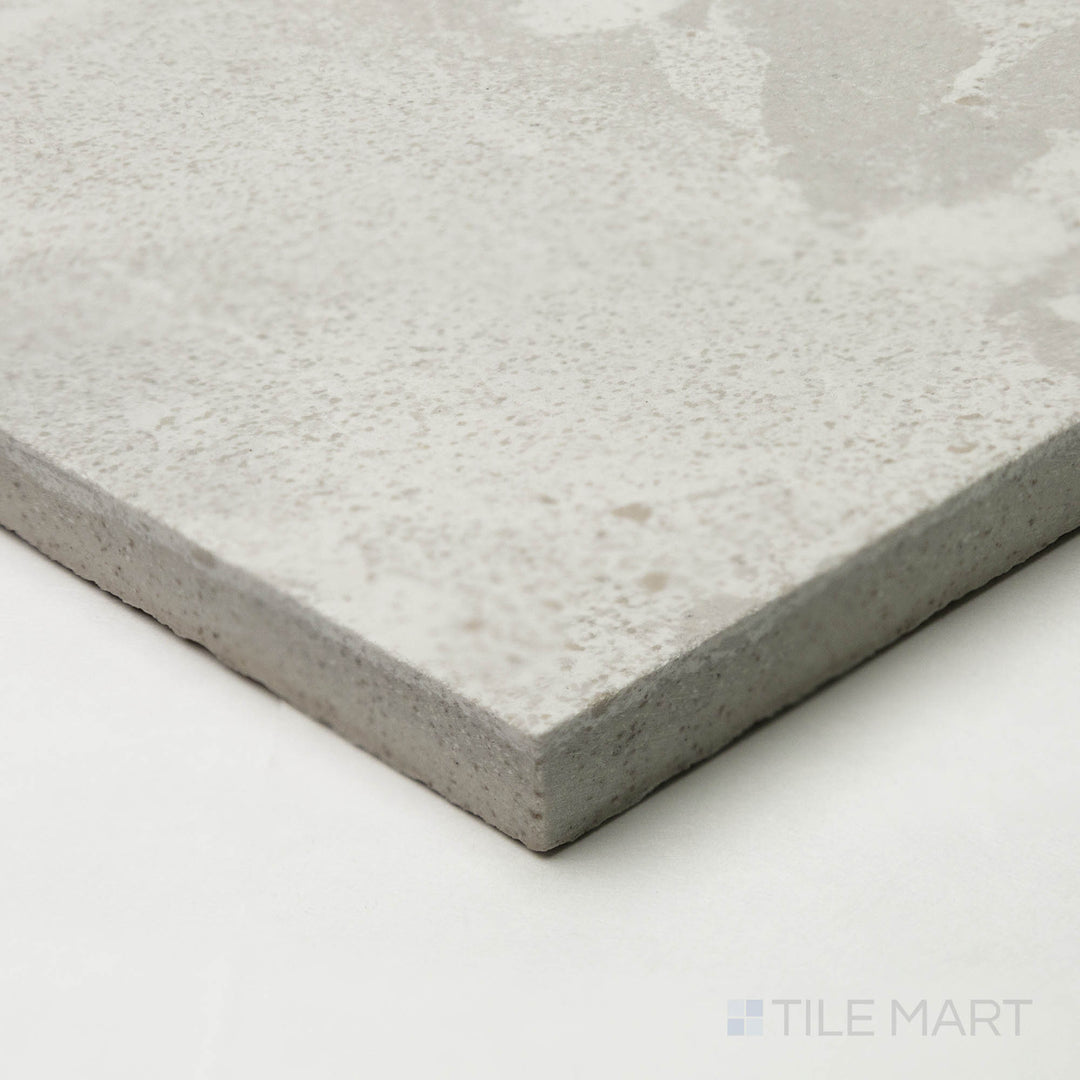 The Attitude White 48x48 natural ceramic tile, seen from a corner perspective, highlights its bright, neutral shade with a crisp junction where edges converge.