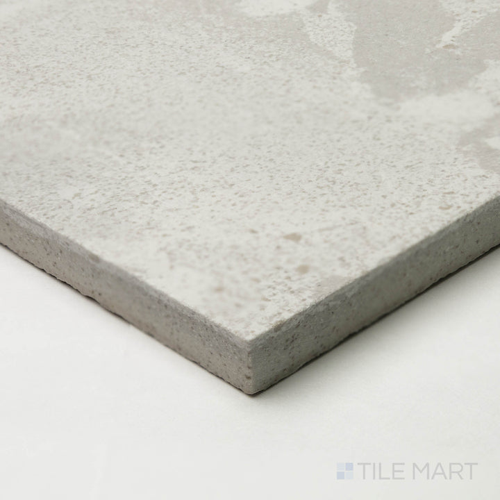 The Attitude White 48x48 natural ceramic tile, seen from a corner perspective, highlights its bright, neutral shade with a crisp junction where edges converge.