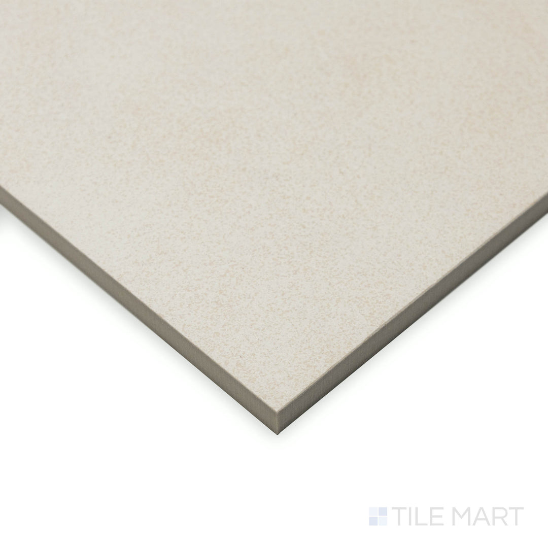 Captured from a side angle, the Crush White 24x48 matte porcelain tile showcases a velvety surface that absorbs light subtly, accentuating its linear, seamless transition.