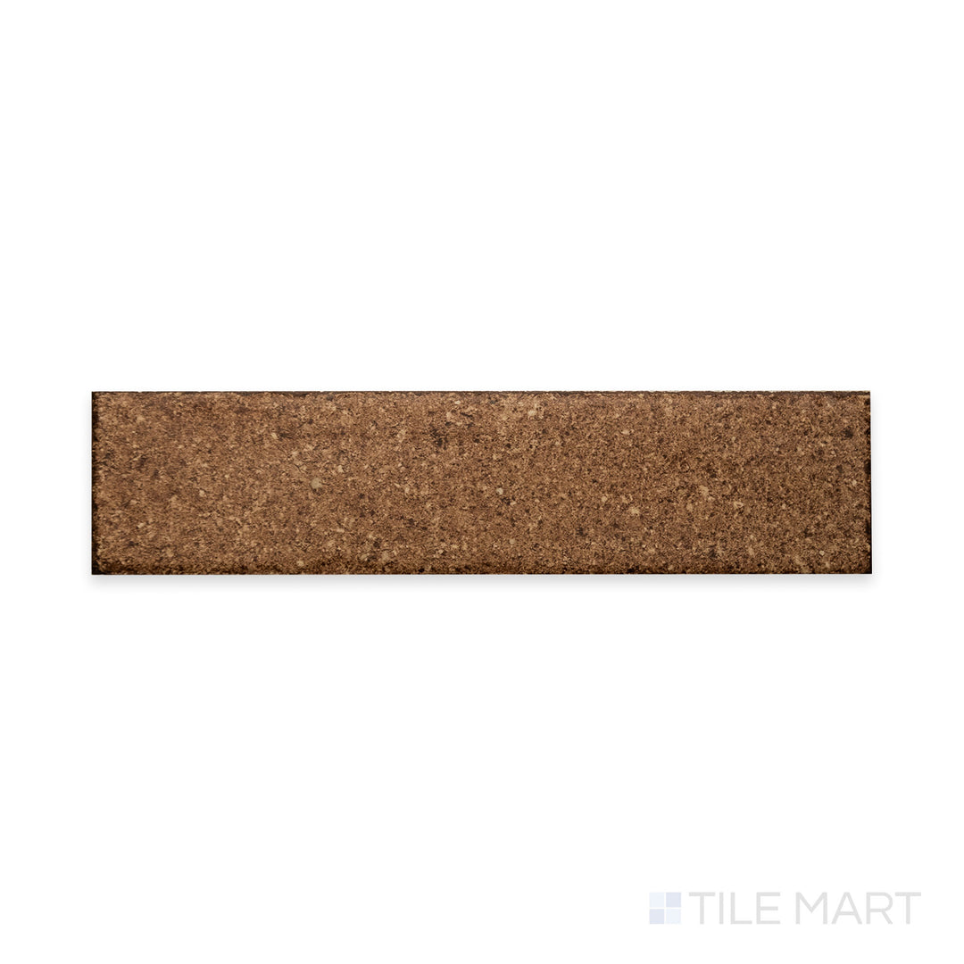 A deep terracotta hue with a matte finish is showcased in this close-up of Block Cotto 2x8 matte porcelain tile, emphasizing its rustic warmth and smooth texture.