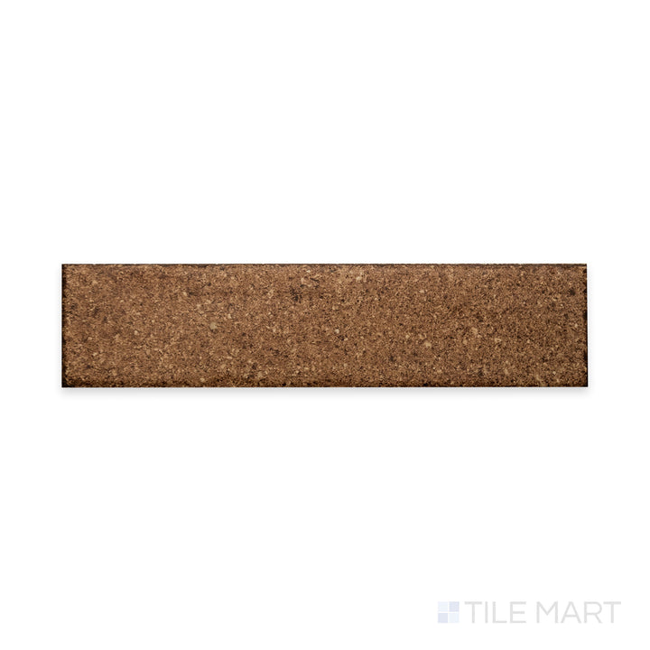 A deep terracotta hue with a matte finish is showcased in this close-up of Block Cotto 2x8 matte porcelain tile, emphasizing its rustic warmth and smooth texture.