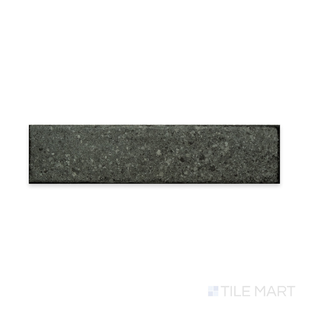 A rich dark tone with a soft matte surface is captured in this macro shot of Block Dark 2x8 matte porcelain tile, highlighting its sleek and contemporary appeal.