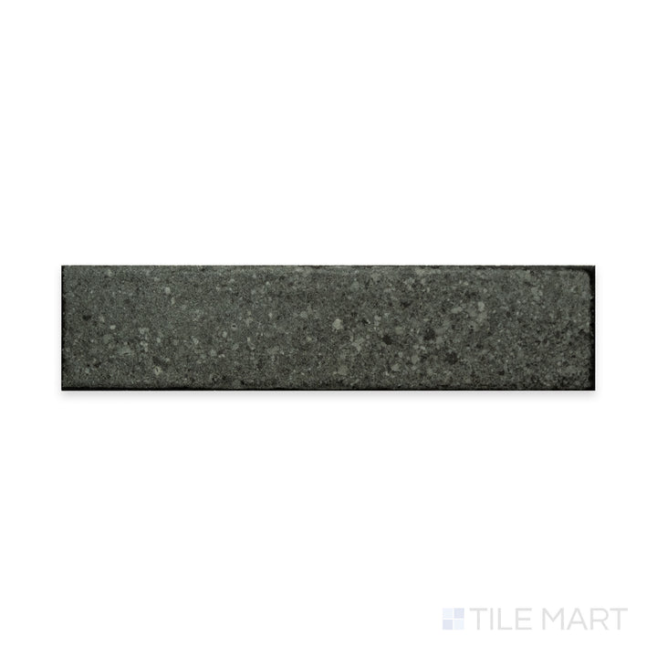 A rich dark tone with a soft matte surface is captured in this macro shot of Block Dark 2x8 matte porcelain tile, highlighting its sleek and contemporary appeal.