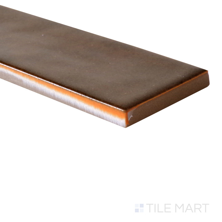 Slanted perspective of Calpe Terra 2x6 glossy porcelain tile, emphasizing its earthy terracotta hues, high-gloss finish, and structured rectangular design.  