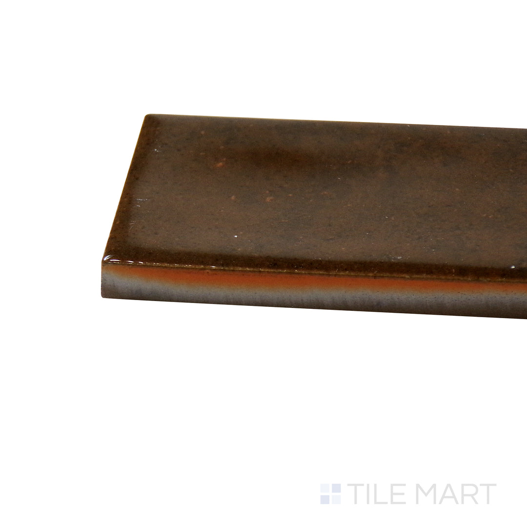 Close-up corner shot of Calpe Terra 2X6 Glossy Porcelain Tile, featuring warm earthy hues with a lustrous, glossy texture.