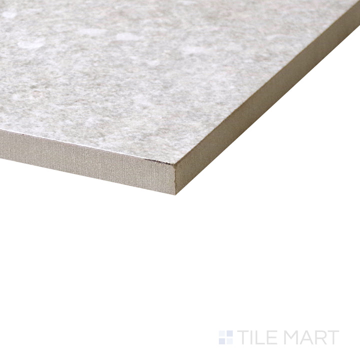 Diagonal view of Dome Bone 24x48 matte porcelain tile, showcasing its warm bone color, refined matte finish, and expansive rectangular format.  