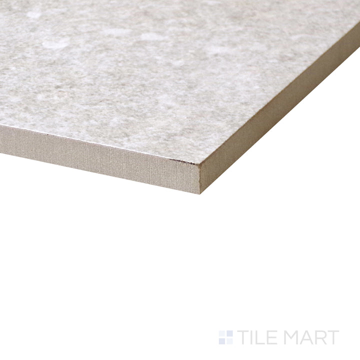 Angled shot of Dome Bone 48x48 matte porcelain tile, featuring soft beige hues, a contemporary matte finish, and a large square format.  