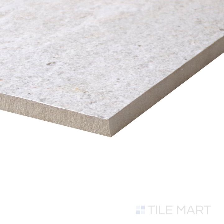 Slanted perspective of Dome Bone 12x36 matte porcelain tile, emphasizing its soft neutral tones, smooth matte texture, and sleek rectangular design.  