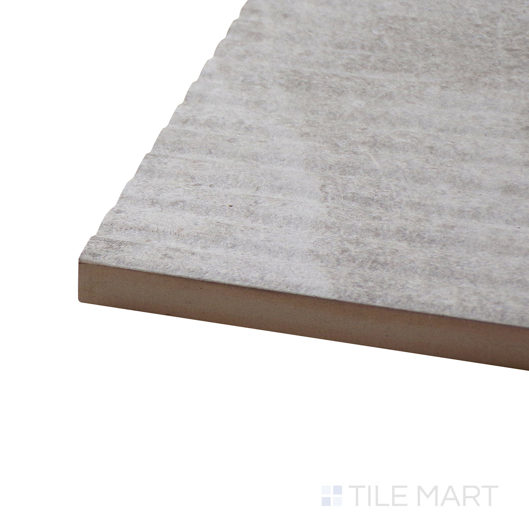 Angled close-up of Dome Bone Deco 12X36 Matte Porcelain Tile, showcasing its intricate decorative design with a neutral matte surface.