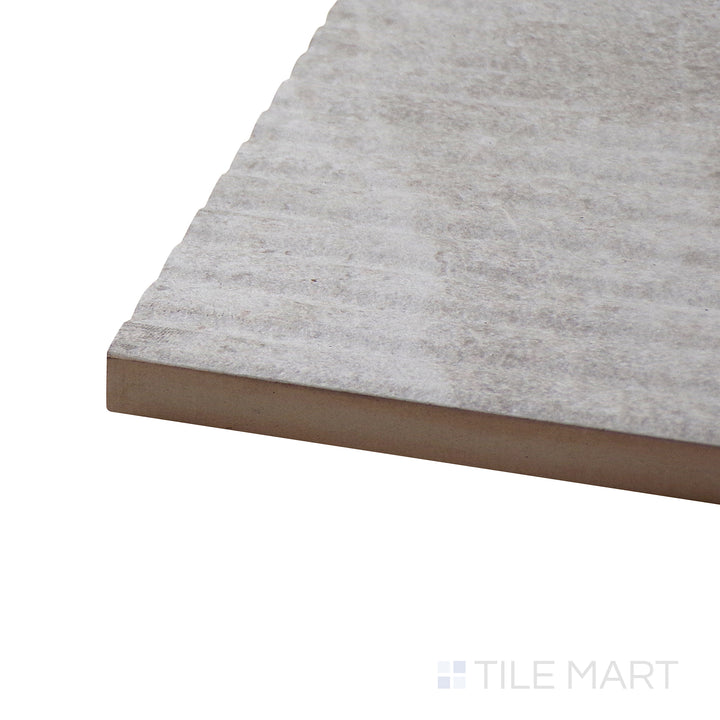 Angled close-up of Dome Bone Deco 12X36 Matte Porcelain Tile, showcasing its intricate decorative design with a neutral matte surface.