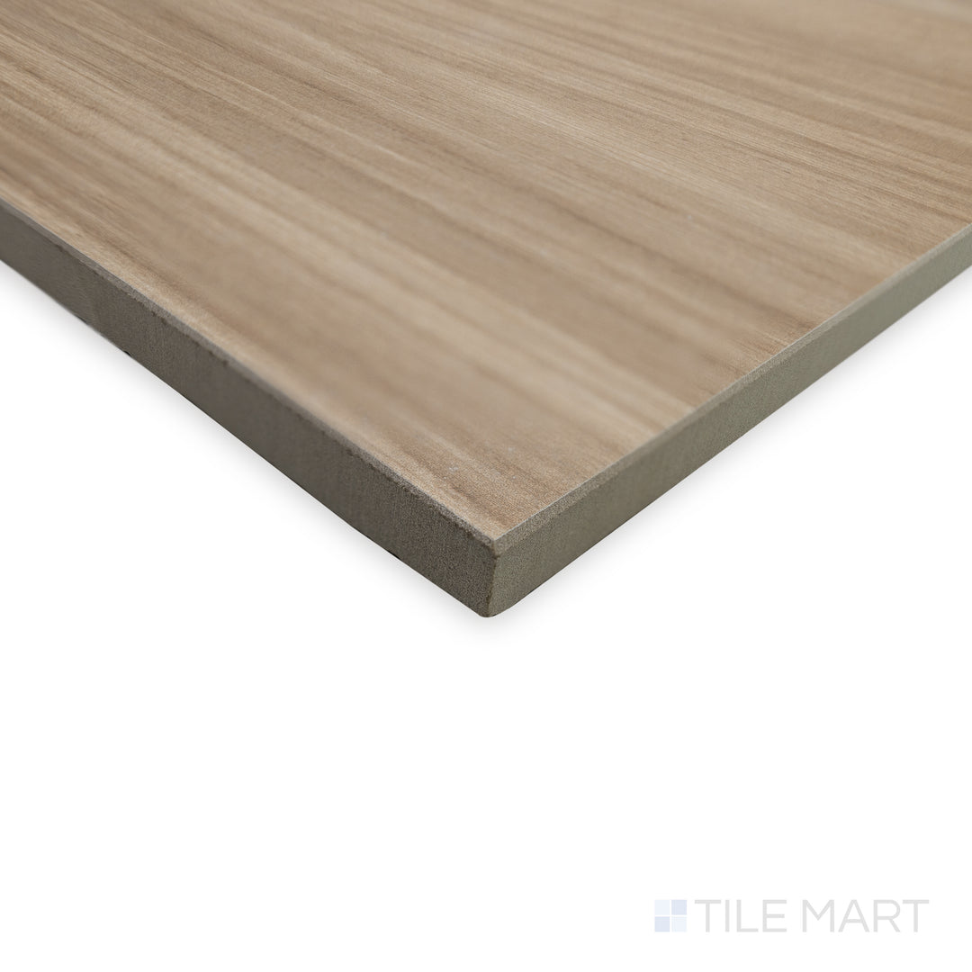 Side-angle view of Dover Camel 10x60 matte porcelain tile, highlighting its soft, earthy hues while focusing on the smooth transition where two edges converge.