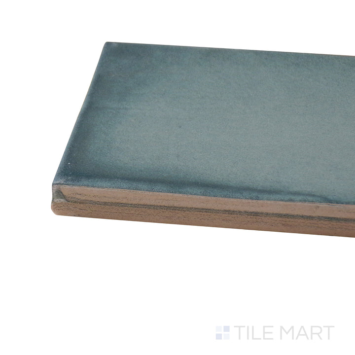 Close-up corner shot of Ghent Smokey Emerald 3X9 Matte Porcelain Tile, featuring its deep emerald green hues with a refined matte finish.